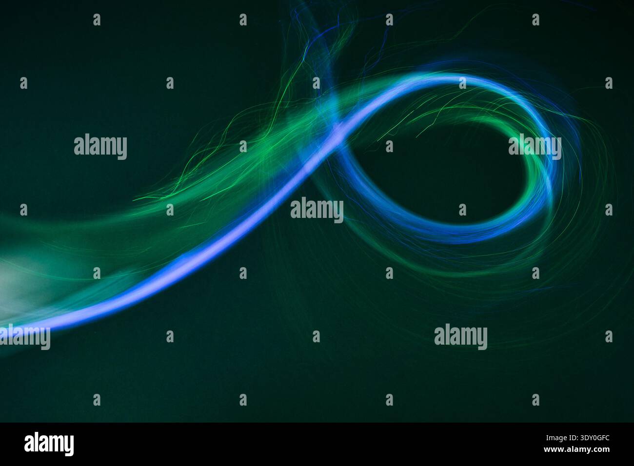 Dynamic blue green light trail swirling concept Stock Photo