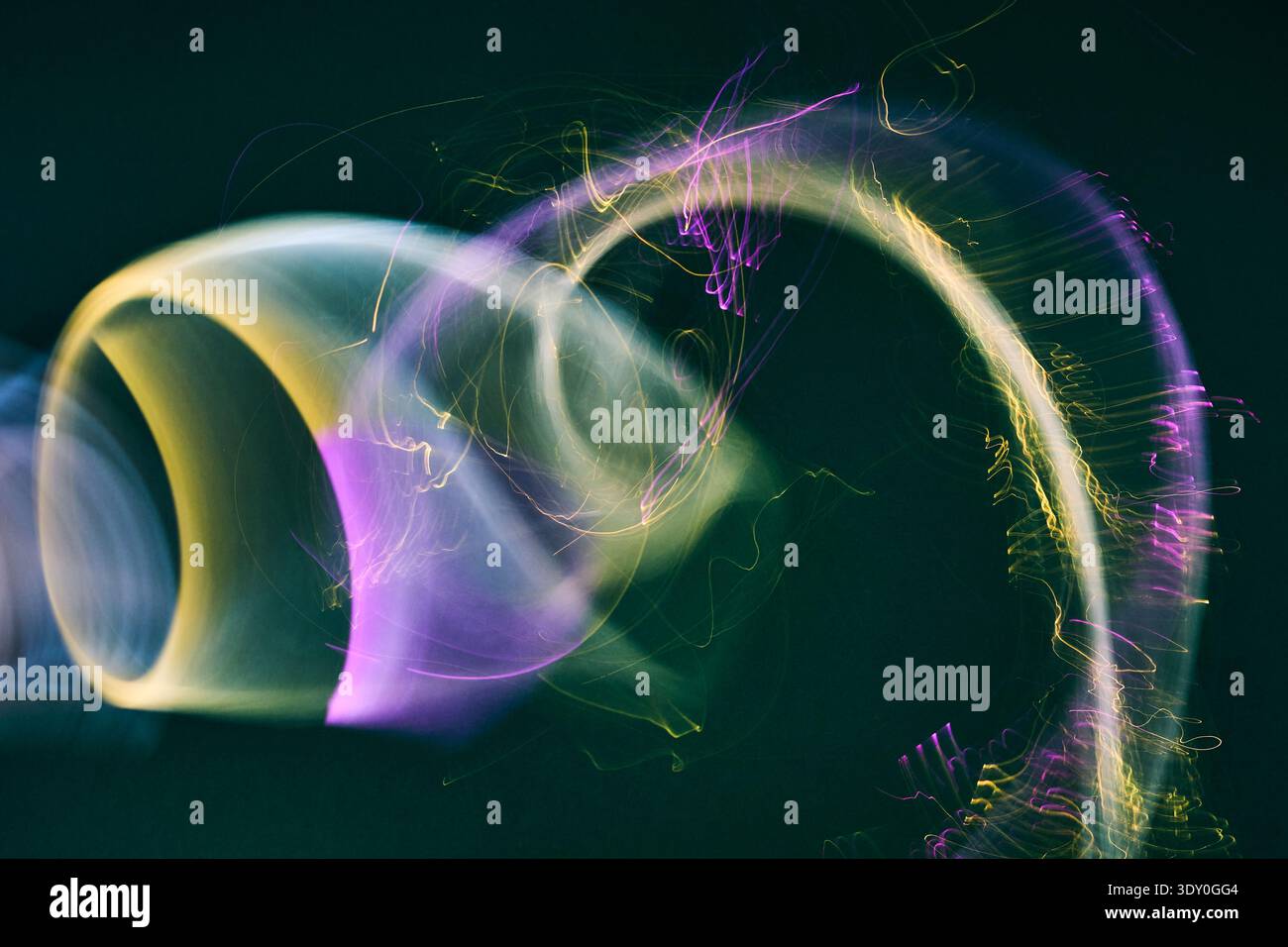 Abstract purple and yellow light trails creating motion Stock Photo