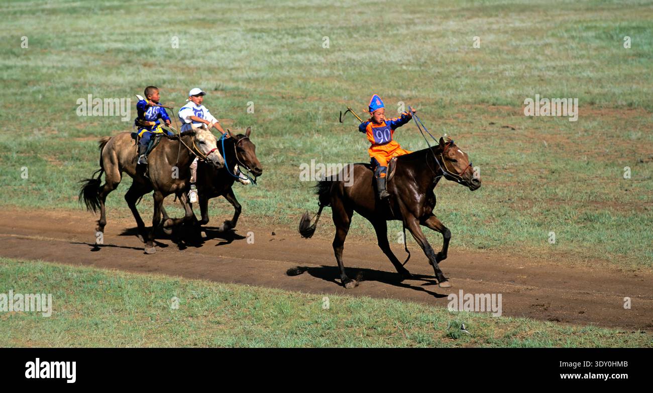 Children compete in a horse race during the Naadam festival in Ulaanbaatar. The event showcases tradition and skill in a lively atmosphere. Stock Photo
