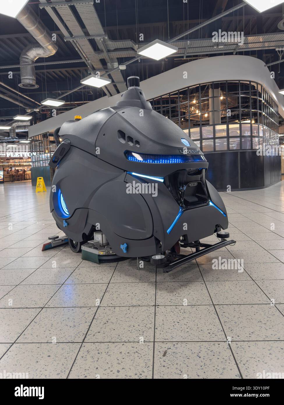 autonomous lionsbot robotic floor cleaning robot machine cleans inside of terminal building at luton airport england uk Stock Photo