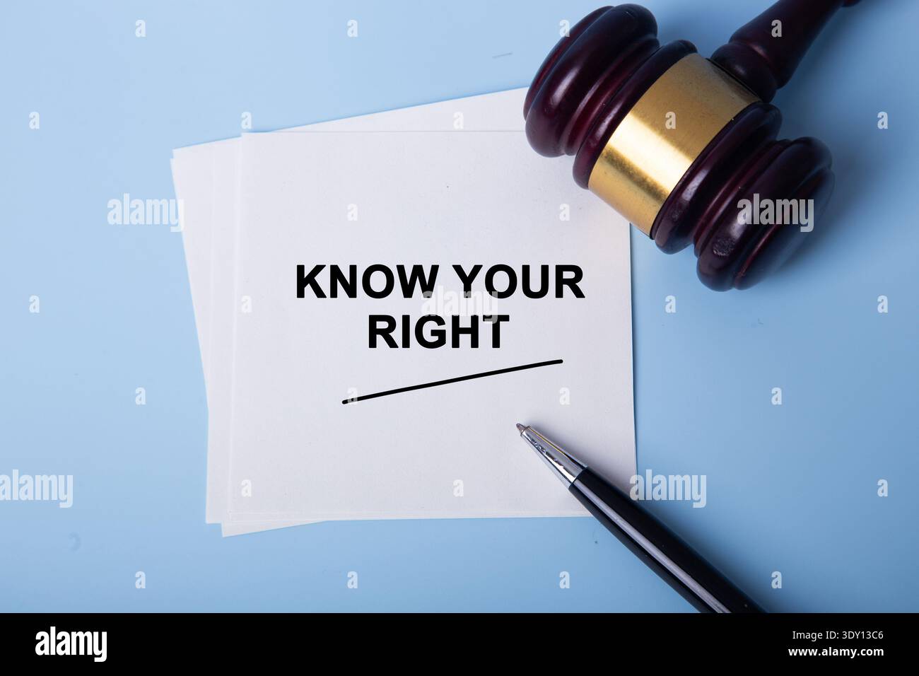 Note with text know your right lying on blue background with gavel and pen Stock Photo
