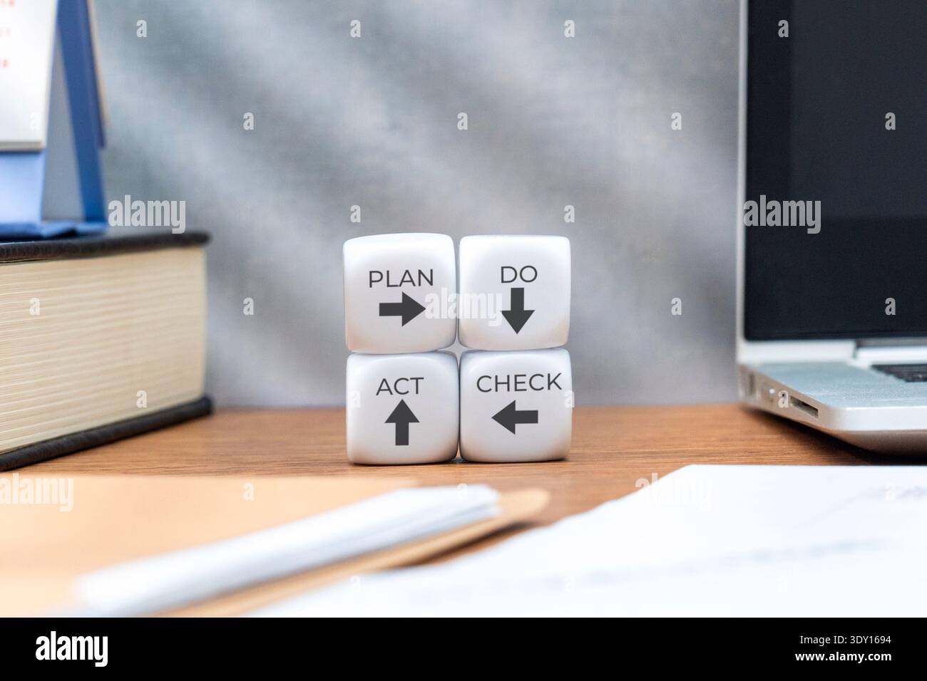 White cubes displaying the PDCA cycle Plan, Do, Check, Act. Quality management, process improvement, continuous development concept. Stock Photo