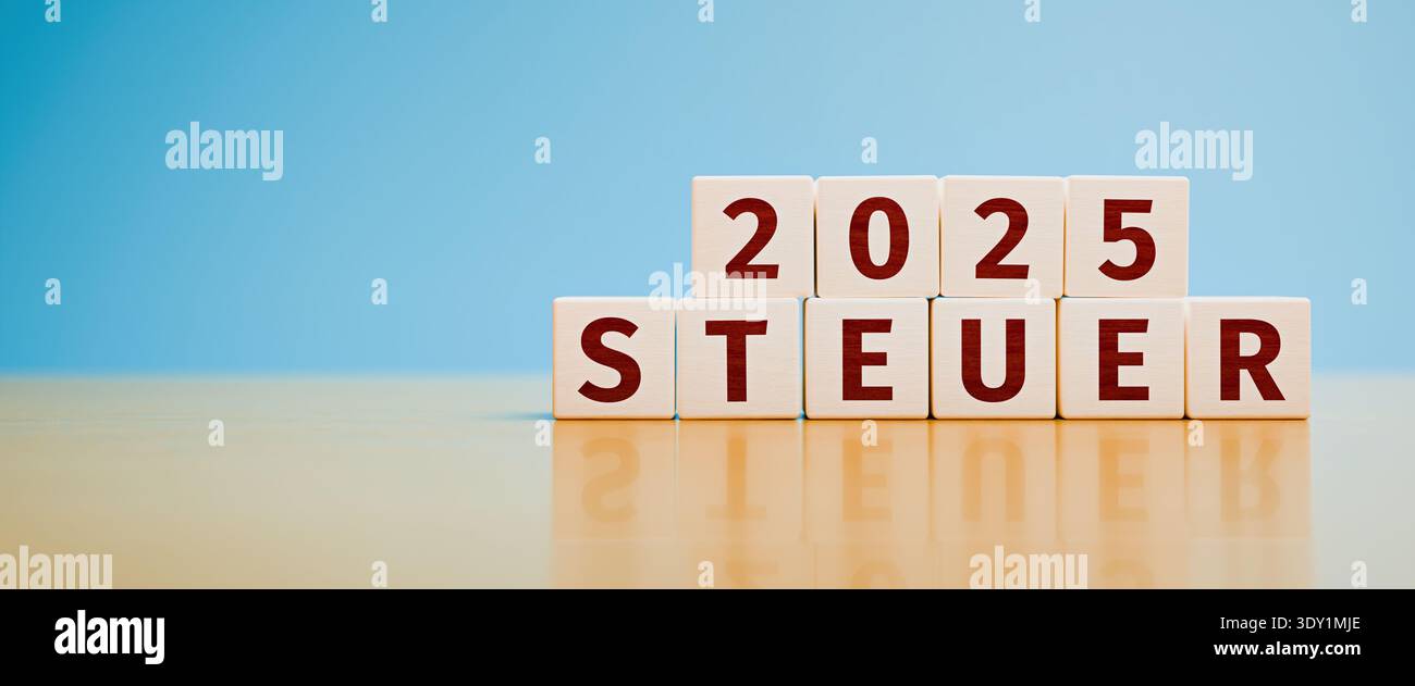 Wooden toy cubes forming the German language text "2025 STEUER" (2025 TAX). Concept for taxes for the year 2025. Stock Photo