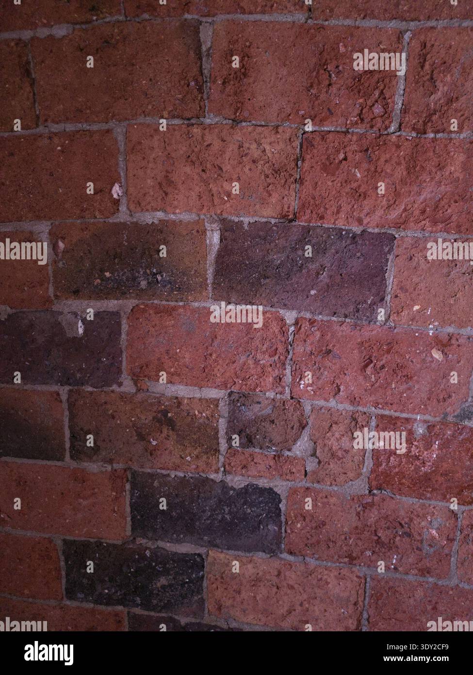 Red Brick Rough Texture The photo shows a wall built with red bricks, characterized by porous ...