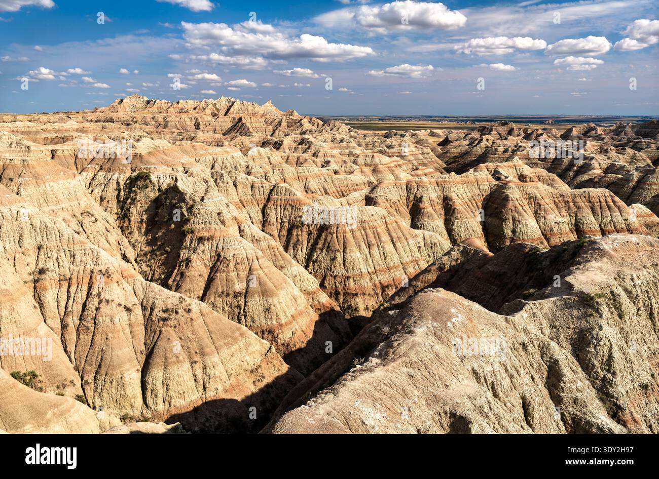Scenic sunny view of the deeply eroded and colorful layered rock ...