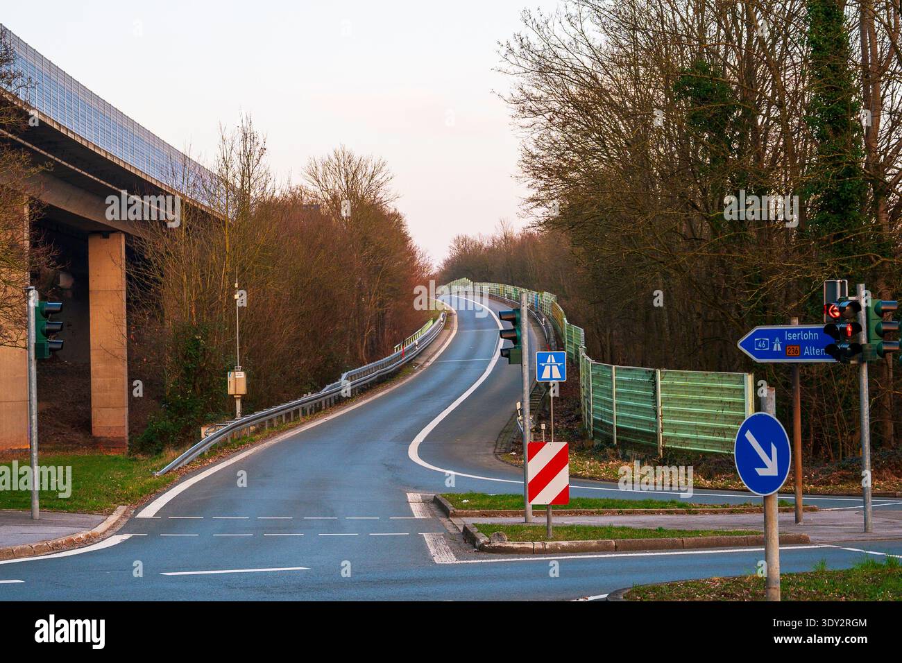 Overpass Signage Curving asphalt road under an overpass with traffic lights and ...