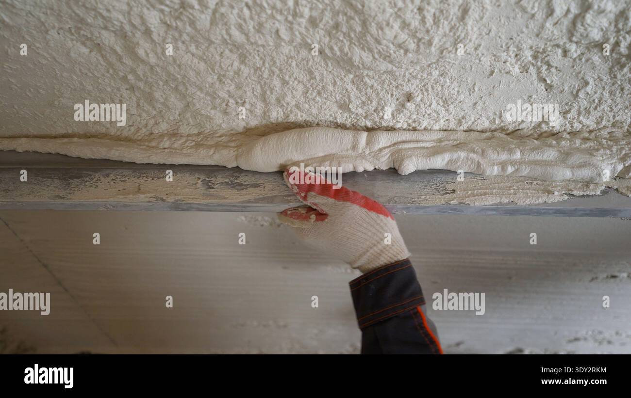 Worker Applying Plaster on a Wall Stock Photo