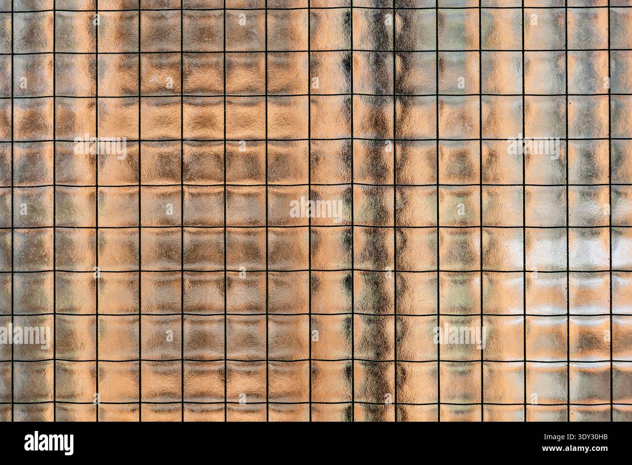 Textured wired glass surface creating an abstract grid pattern background Stock Photo