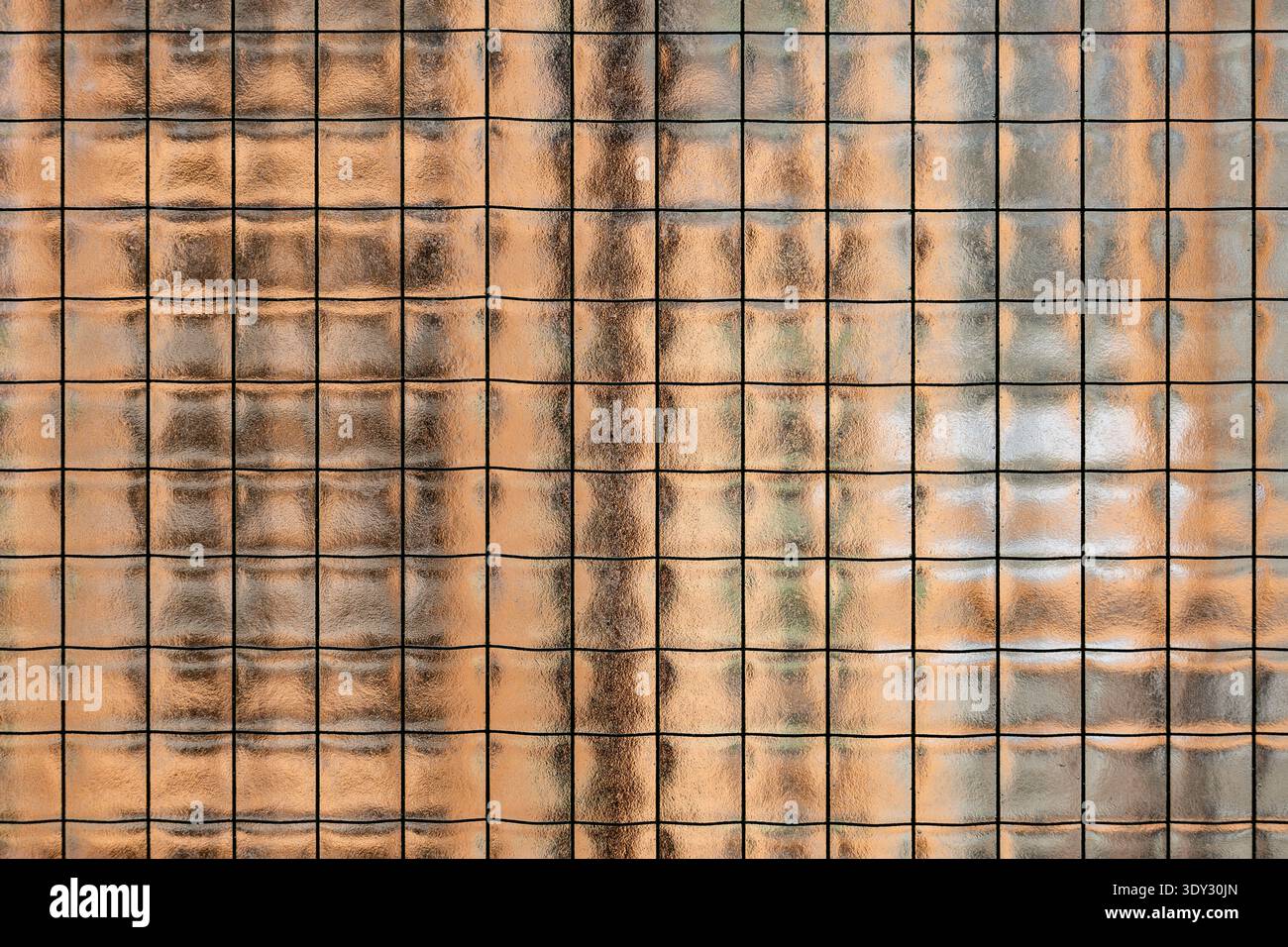 Wired glass panel creating abstract background texture with warm translucent light Stock Photo