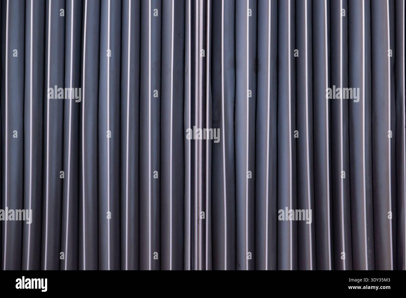 Abstract metal surface showing vertical lines and repeating industrial pattern Stock Photo