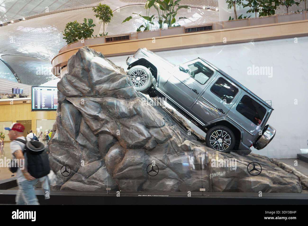 Modern luxury SUV display on a rock installation at Istanbul International Airport terminal, showcasing automotive design and engineering. Stock Photo