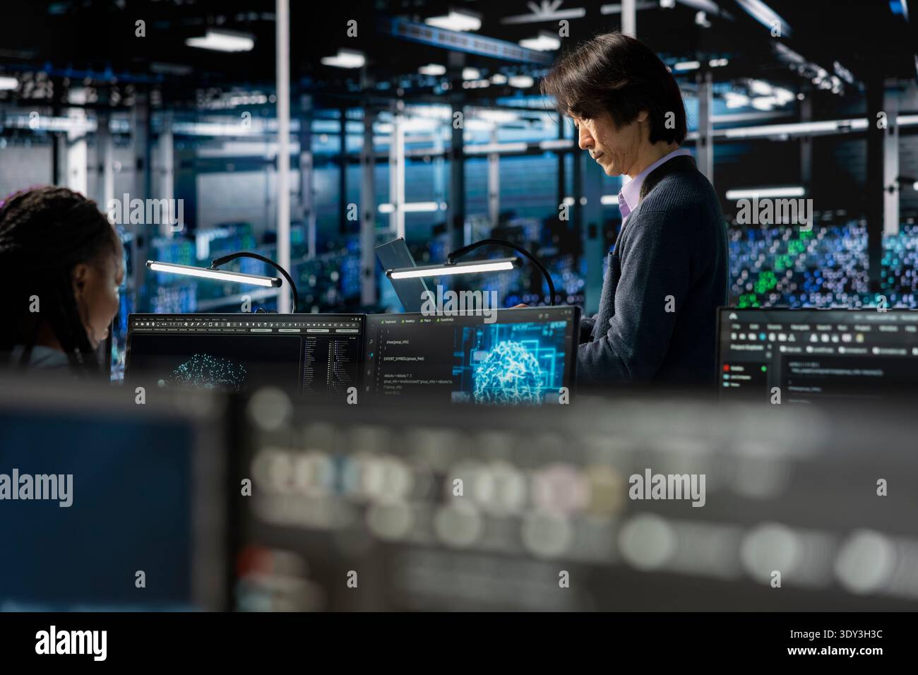 Data center system administrators adjusting AI model parameters to enhance accuracy. Server farm IT experts scheduling artificial intelligence ran maintenance for hardware components Stock Photo