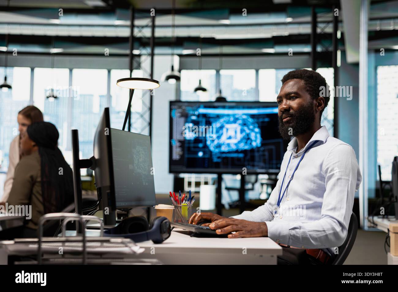 System administrator writing code, developing machine learning APIs. African american man in office troubleshooting application errors using artificial intelligence tech on green screen computer Stock Photo