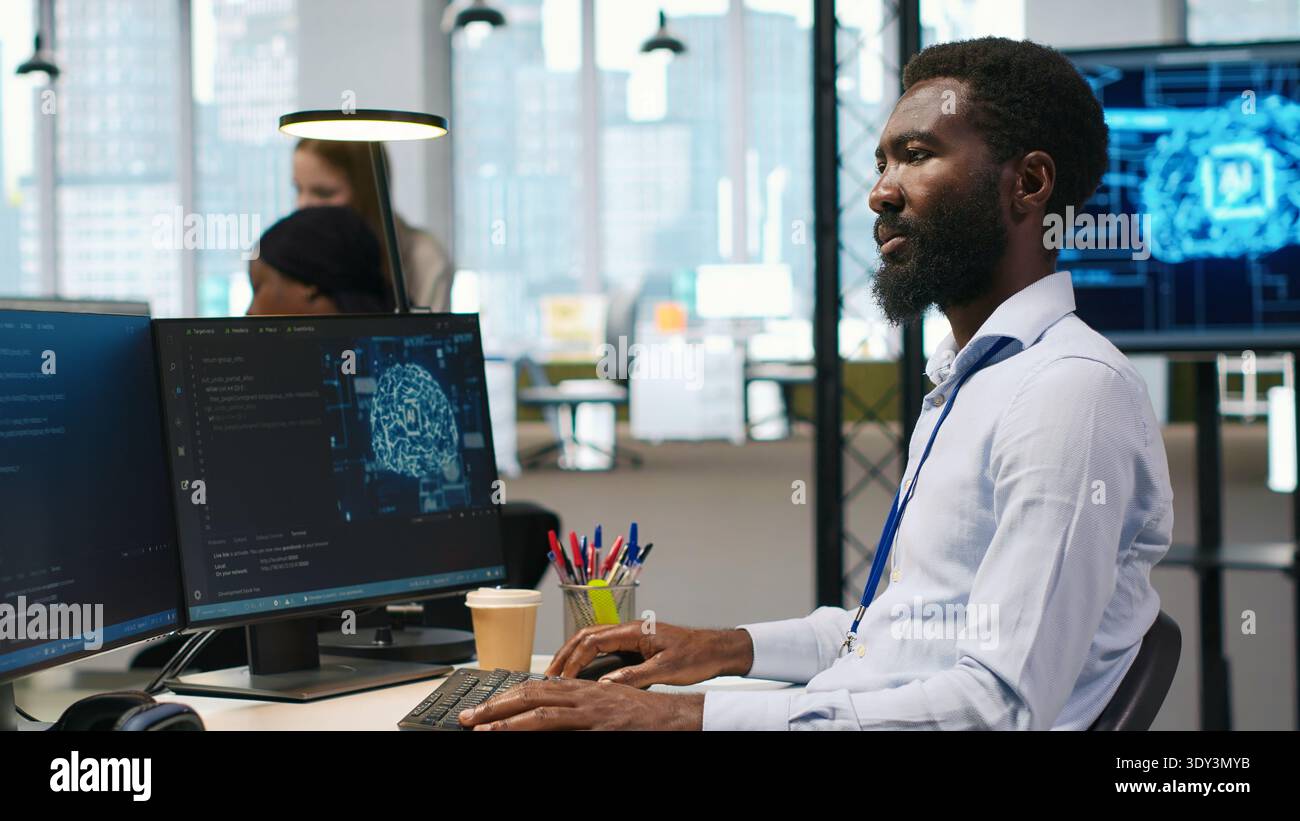 Software developer writing code on PC, developing deep learning APIs. IT professional using computer to troubleshoot software errors using artificial intelligence technology, camera A Stock Photo