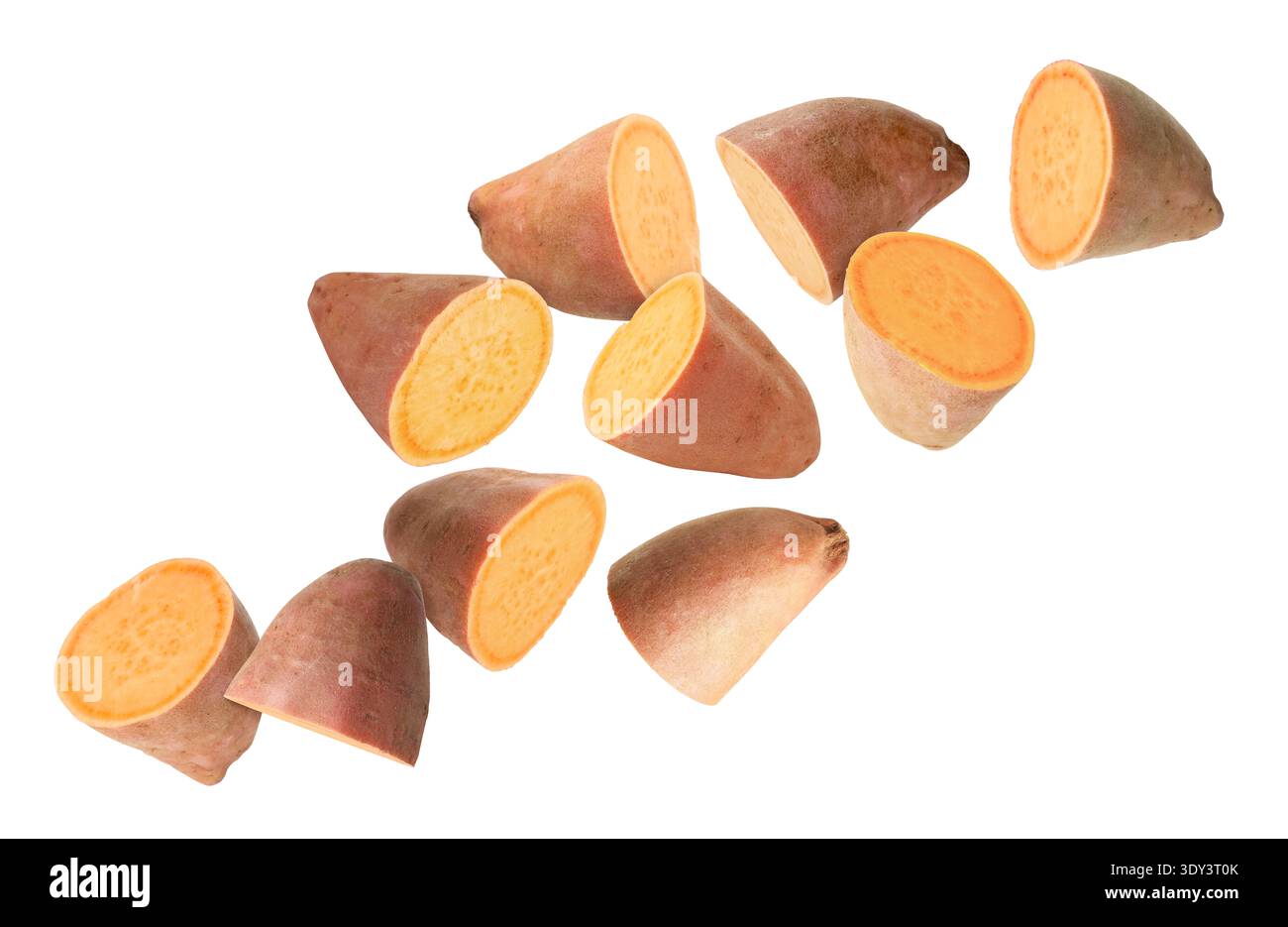 Sweet potato pieces falling against white background Stock Photo