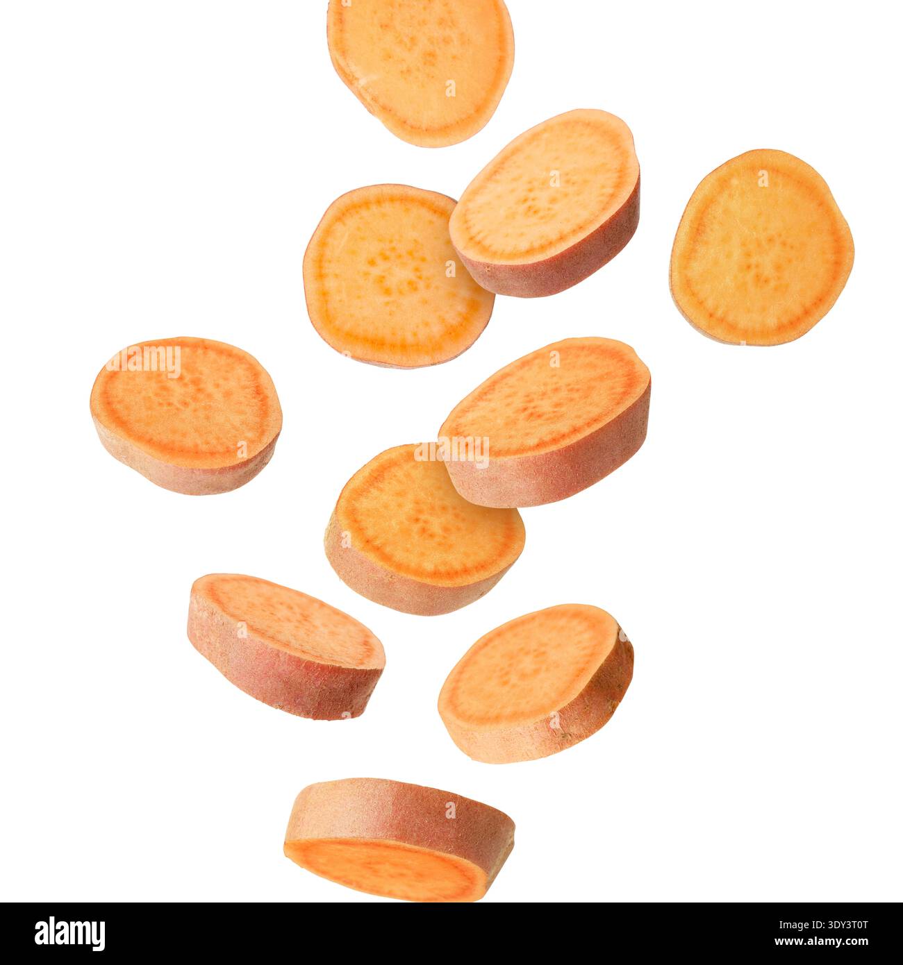 Sweet potato pieces falling against white background Stock Photo
