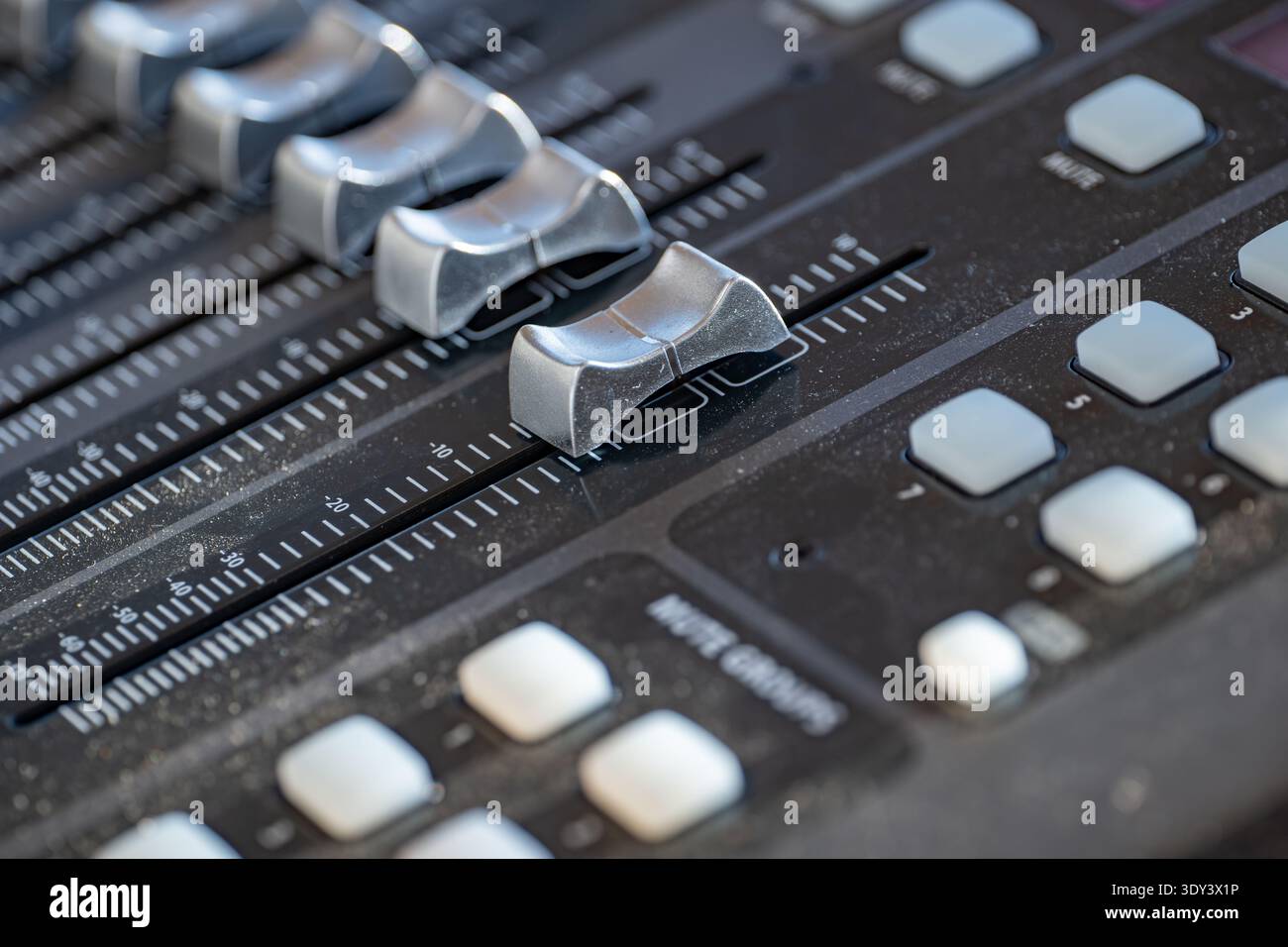 Audio mixing console faders and control buttons for live music ...
