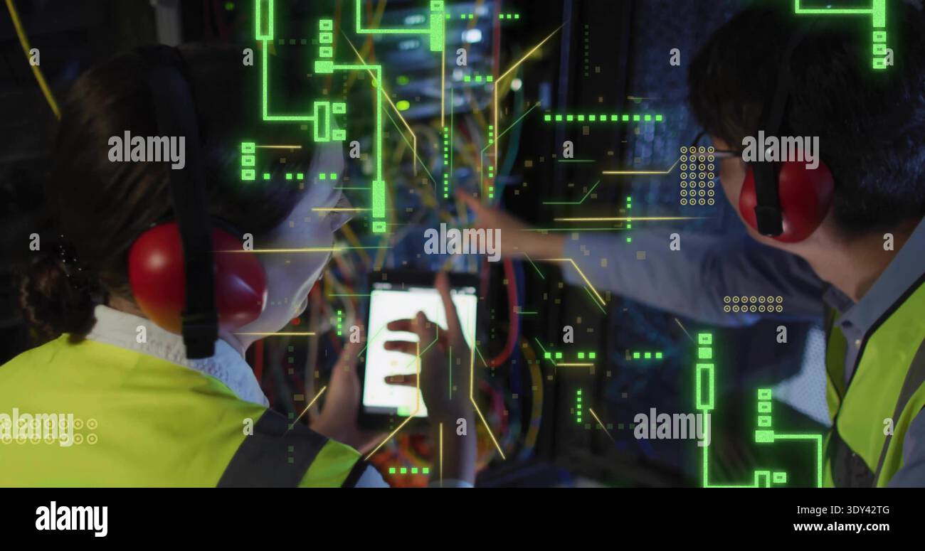 Working two technicians in hivis vests, red muffs, using tablet routing rack cables with AR overlay Stock Photo