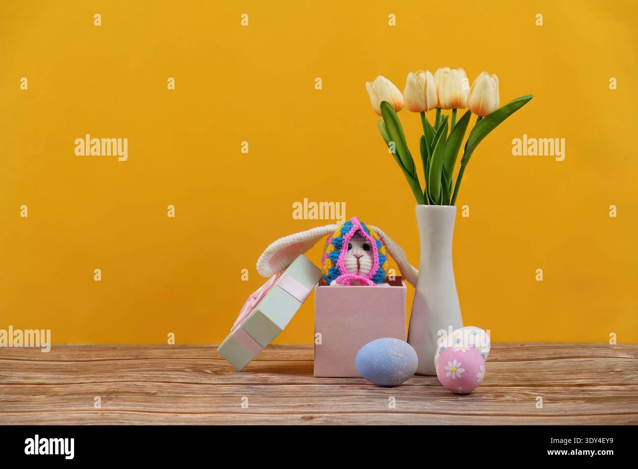 Easter Bunny Surprise. Cute bunny and colorful eggs in a festive spring setting. Stock Photo