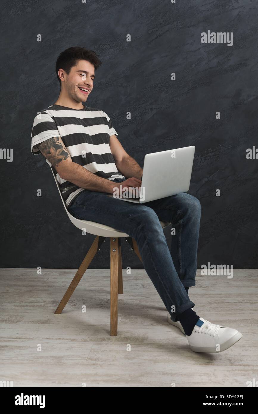 Handsome man using laptop in studio Stock Photo