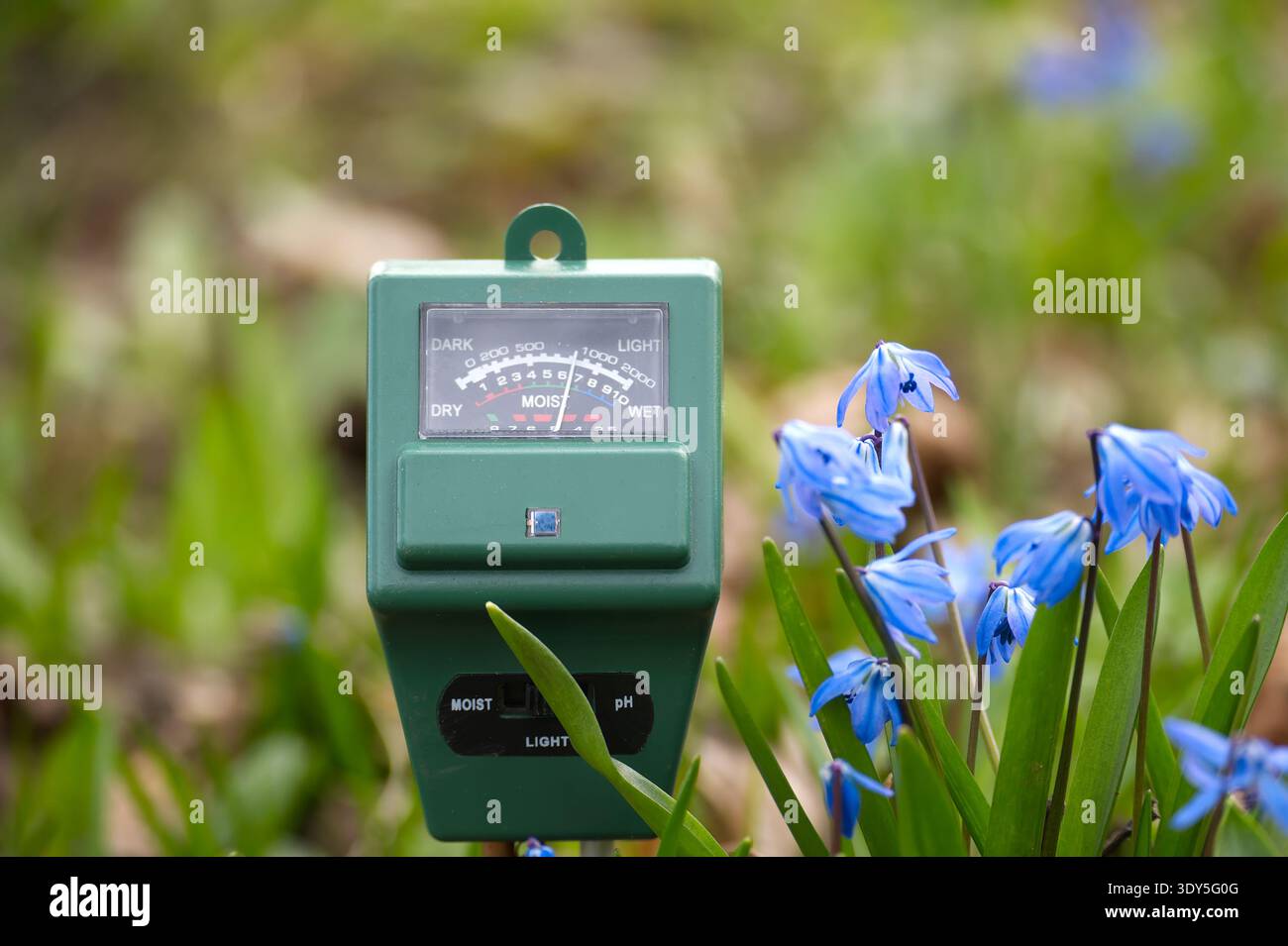 Spring Flower Meter A green soil meter with a dial displays readings for moisture, light ...