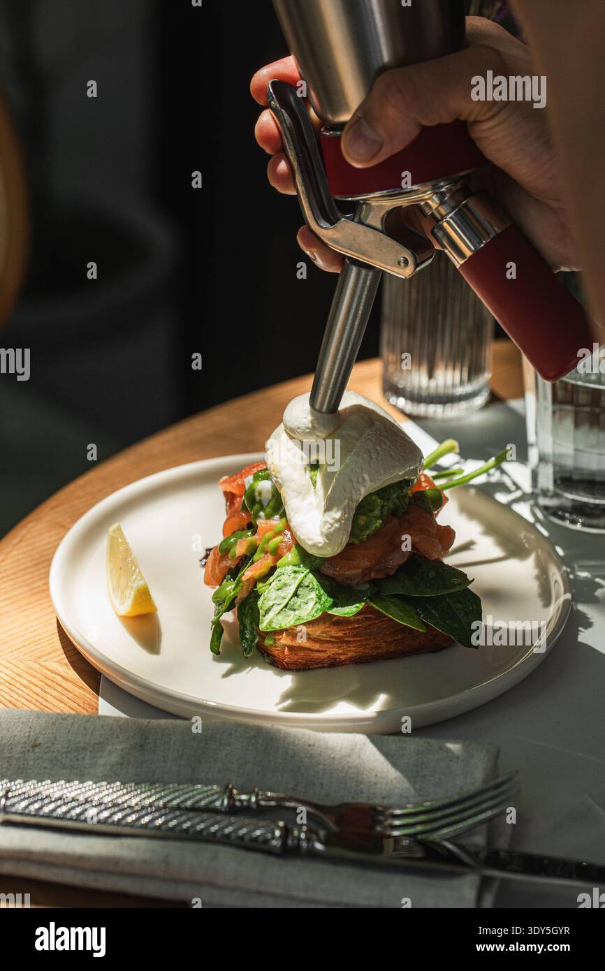 Salmon toast with poached egg and spinach Stock Photo