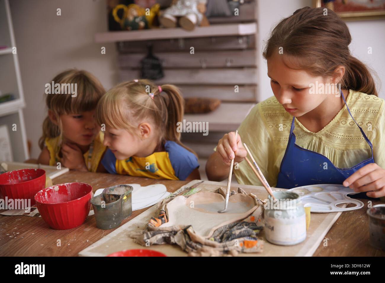 Kids molded from clay at pottery class. || Model released Stock Photo