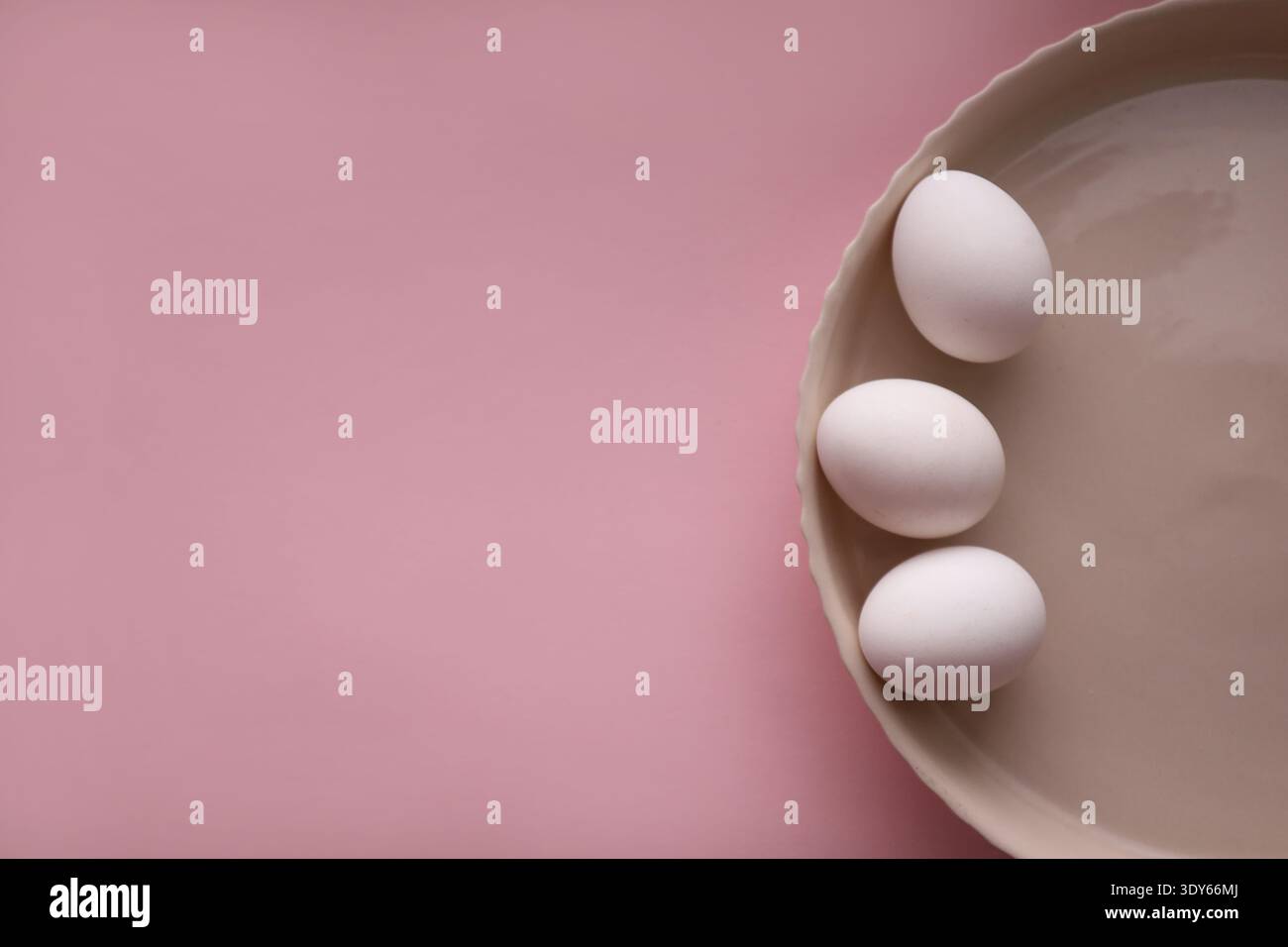composition of three eggs on round ceramic plate Stock Photo