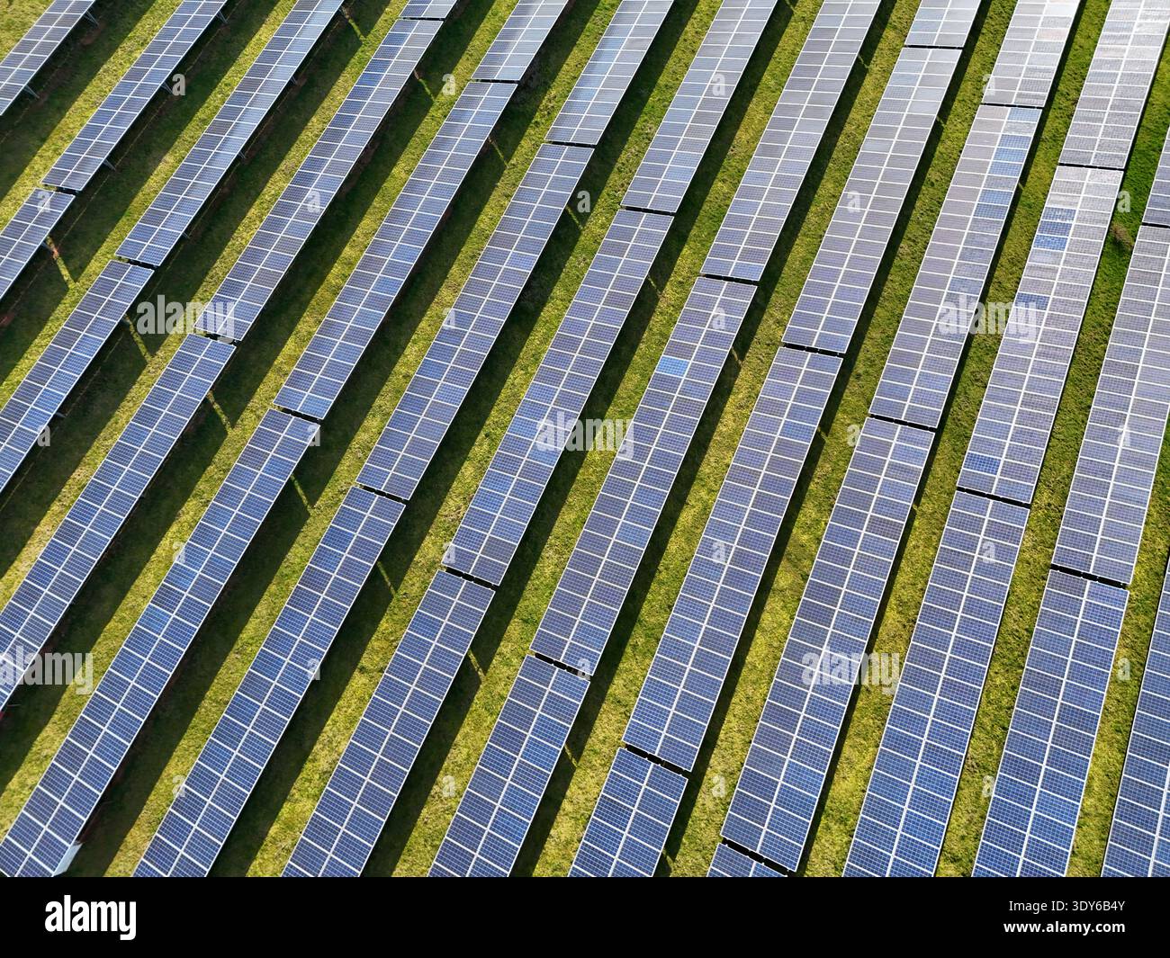 Aerial view of photovoltaic solar panel arrays arranged in diagonal ...