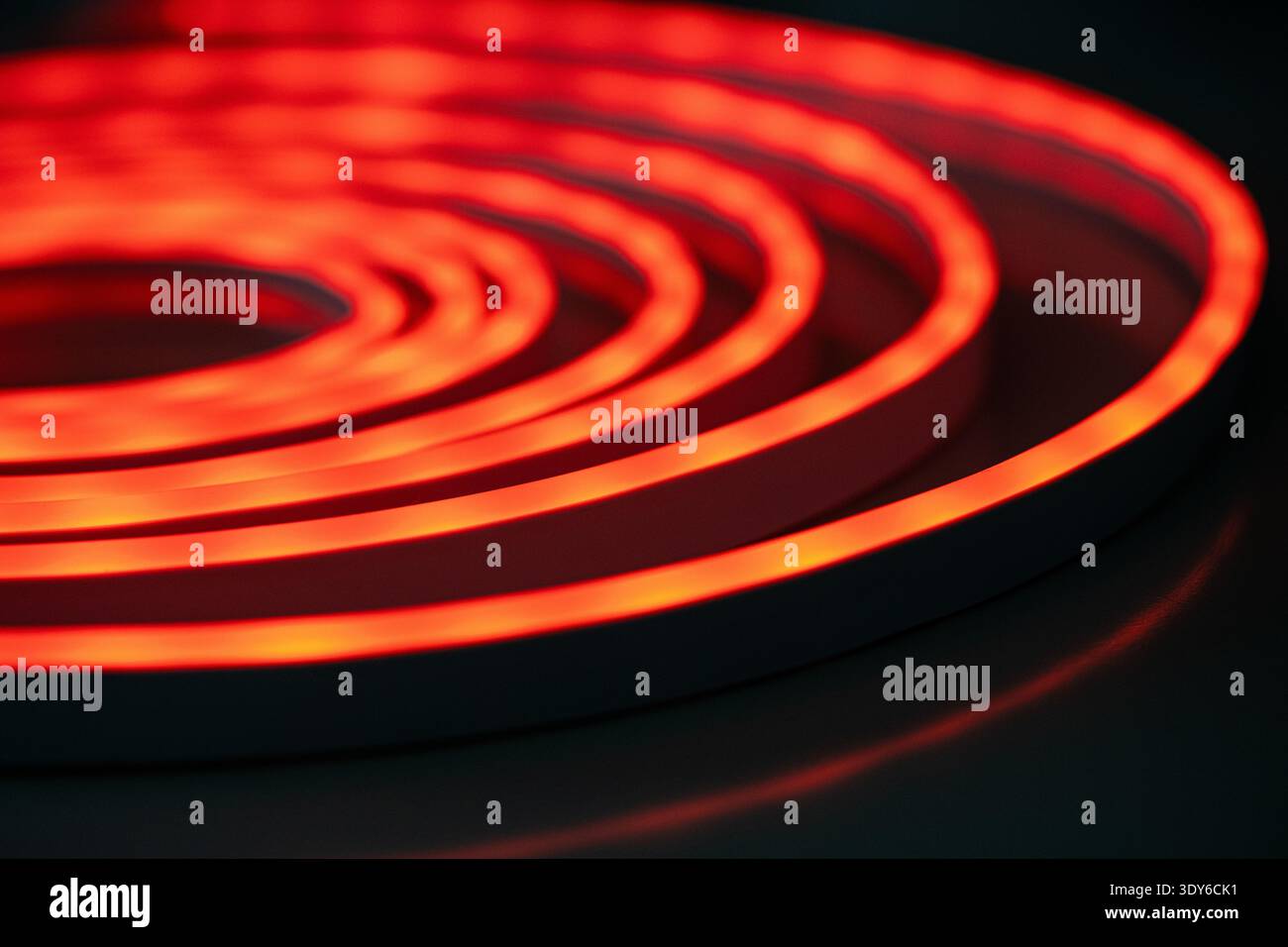 Red glowing spiral neon light abstract pattern Stock Photo