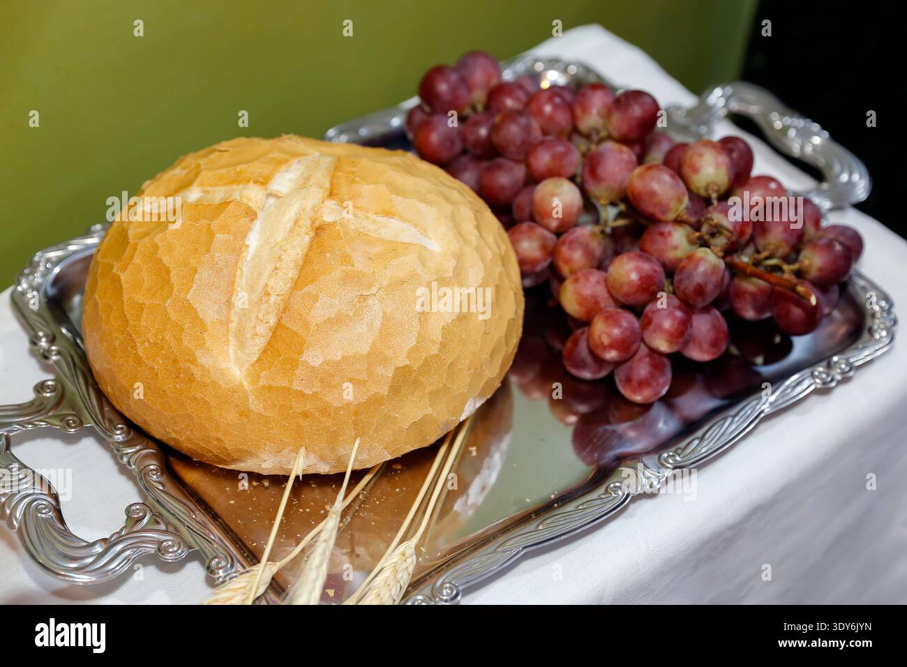 Representational Ritual Symbolic Eucharist representation with bread and grapes on a metallic ...