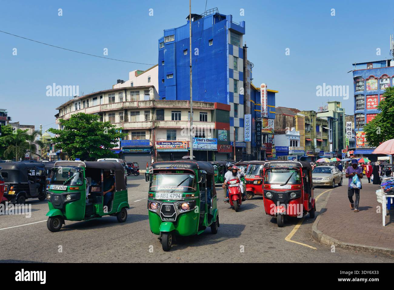 Motorized tuk tuk in a busy shopping street in Colombo during the day Stock Photo