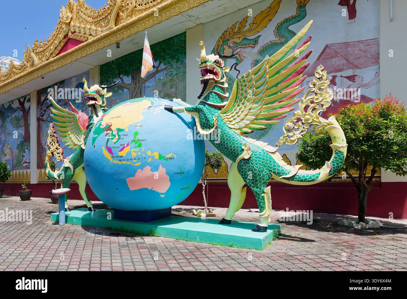Statues of mythical creatures around globe at Dhammikarama Burmese Buddhist Temple in Penang, Malaysia Stock Photo