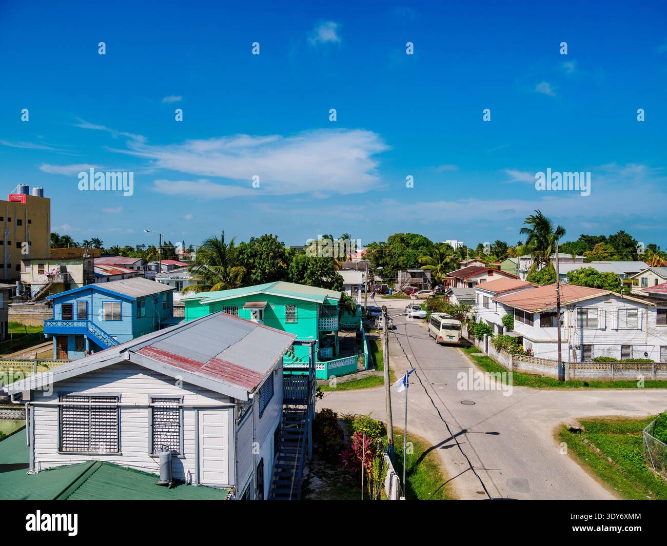 View of residential areas in Belize City with blue skies and nearby streets in Belize District during the day Stock Photo