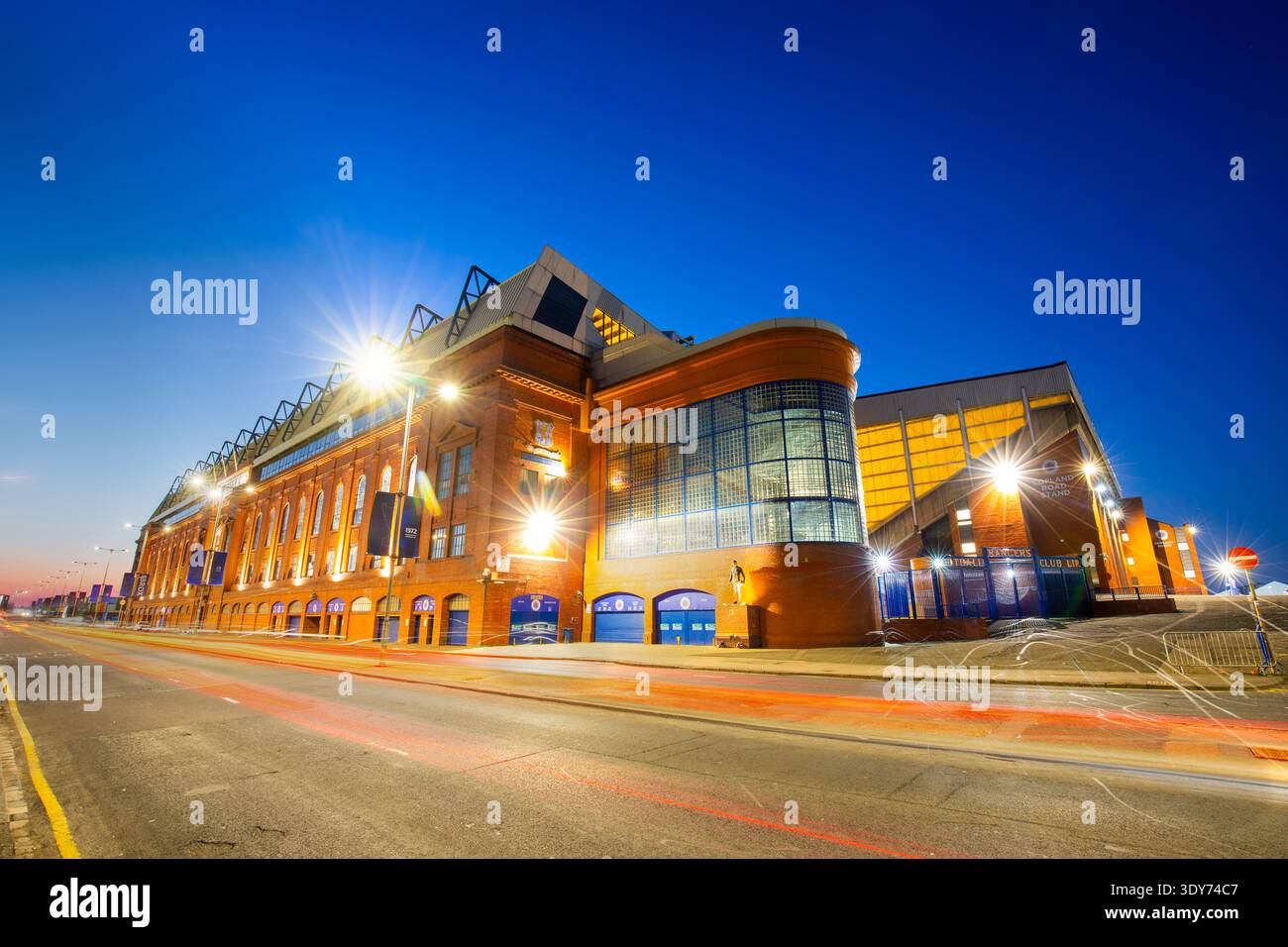 Evening lights shine at Ibrox Stadium, home of Rangers Football Club in Glasgow, Scotland Stock Photo