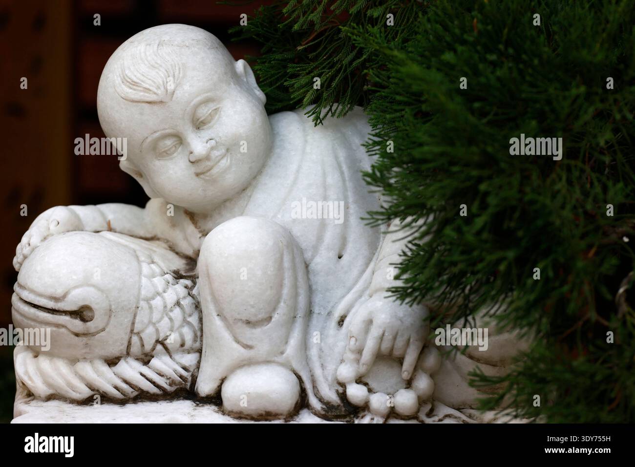 Marble statue of a Buddhist monk in a garden at a temple in Vietnam Stock Photo