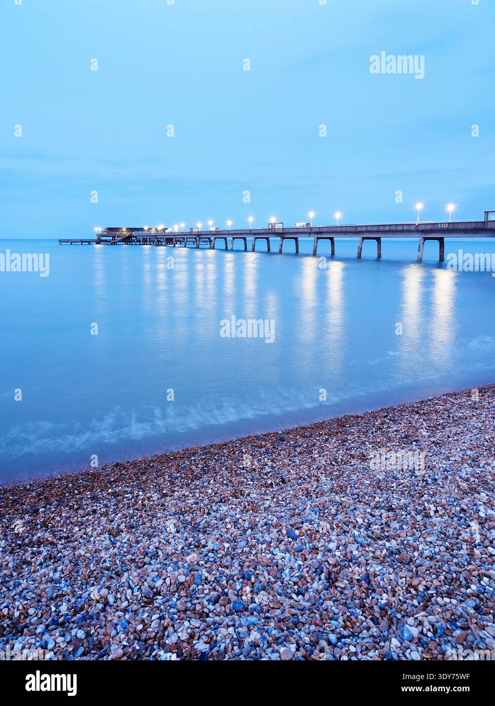 View of the pier at dusk with reflections on the water in Deal Kent Stock Photo