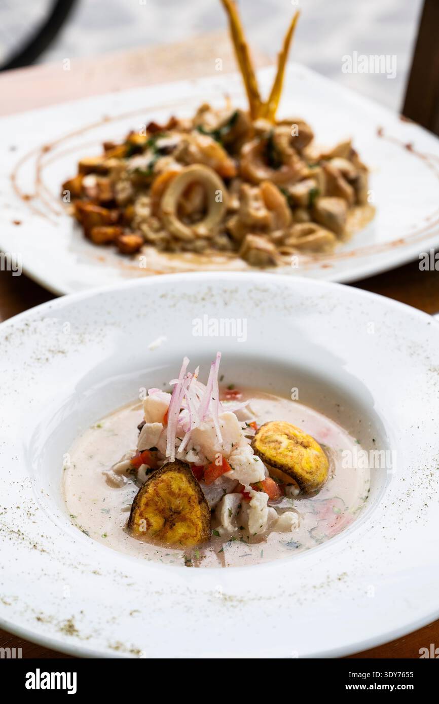 Delicious seafood dish served with plantains and a view of local cuisine from the Galapagos Islands Stock Photo