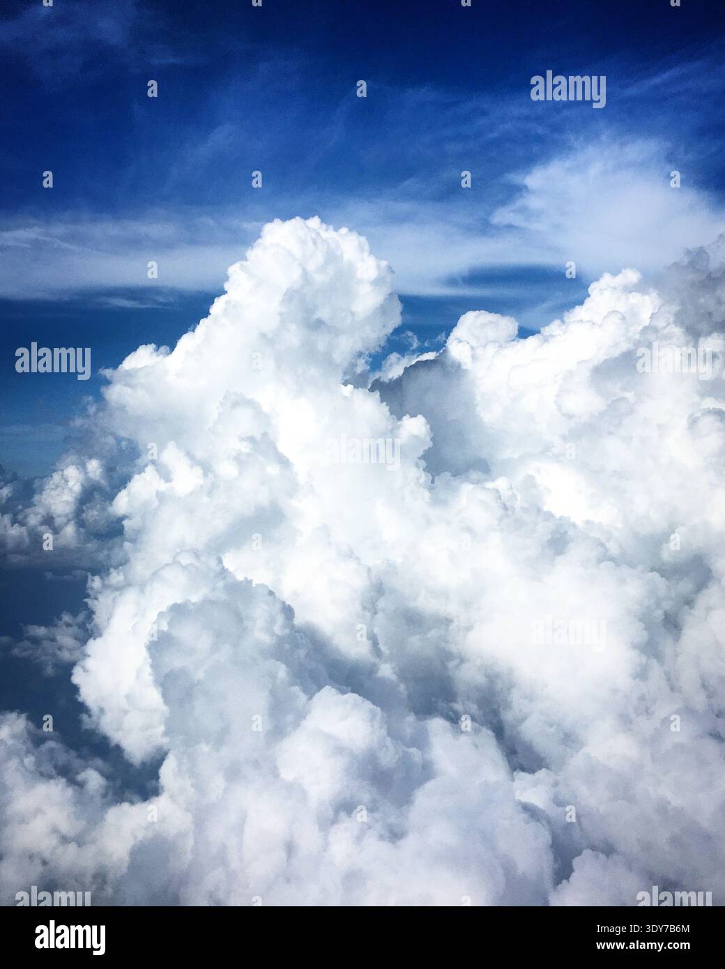 Aerial view of the huge cumulus clouds in a vibrant blue sky over Sri ...