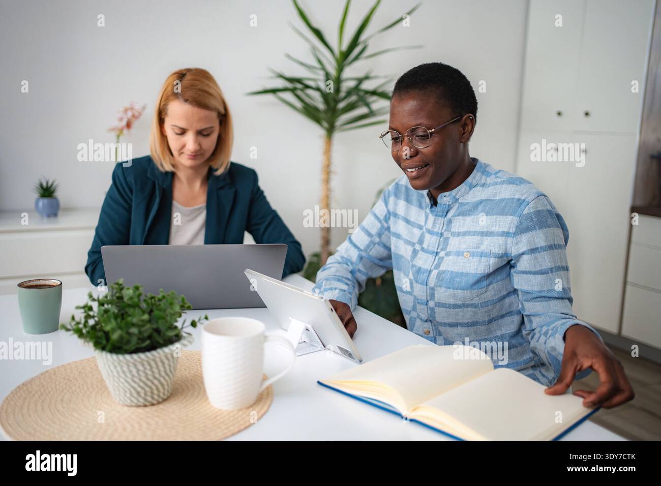 Diverse women working remotely from home office Stock Photo