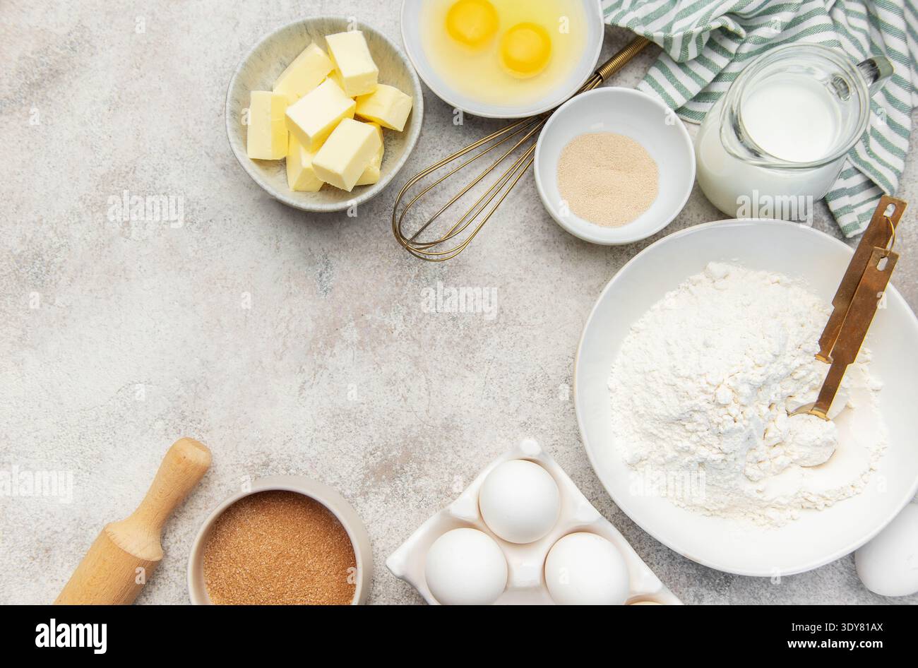 Assorted fresh ingredients for baking dough on a light kitchen counter background Stock Photo