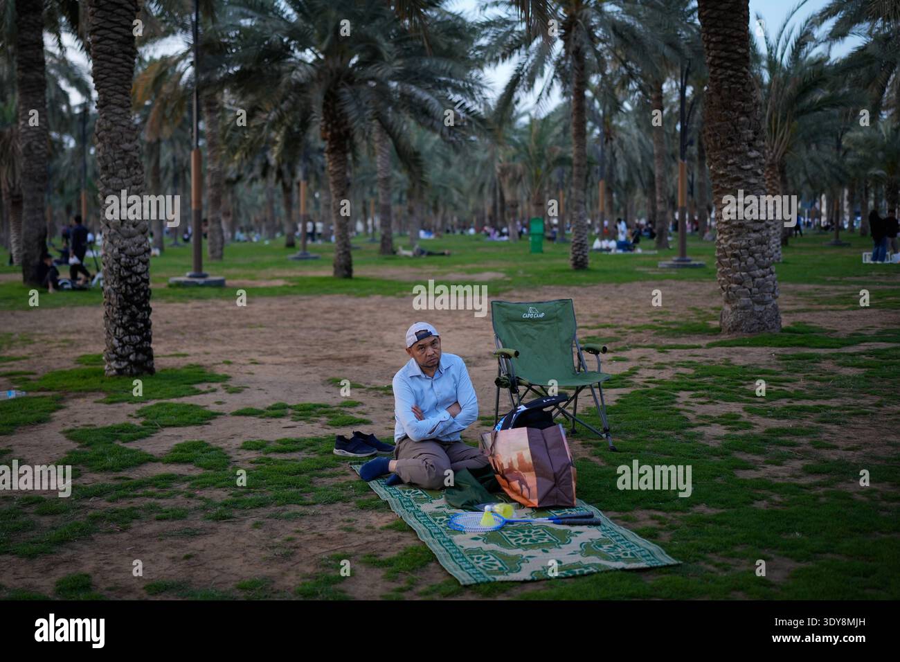 A Muslim man waits for Iftar, the meal that breaks the day-long fast ...