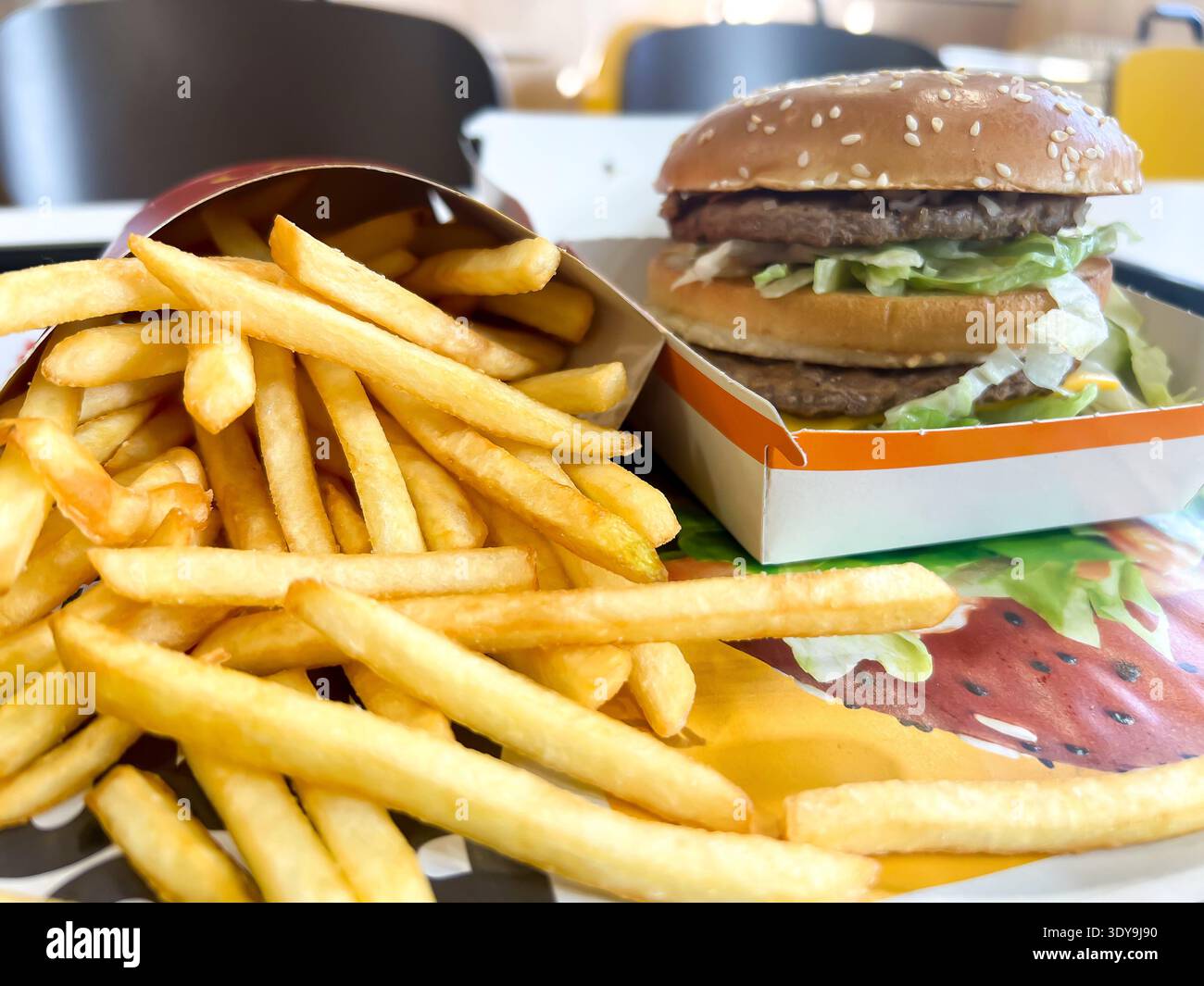 Close up view of a medium sized portion of Mcdonalds fries and a Big Mac hamburger for lunch - Smartphone Captured Stock Image