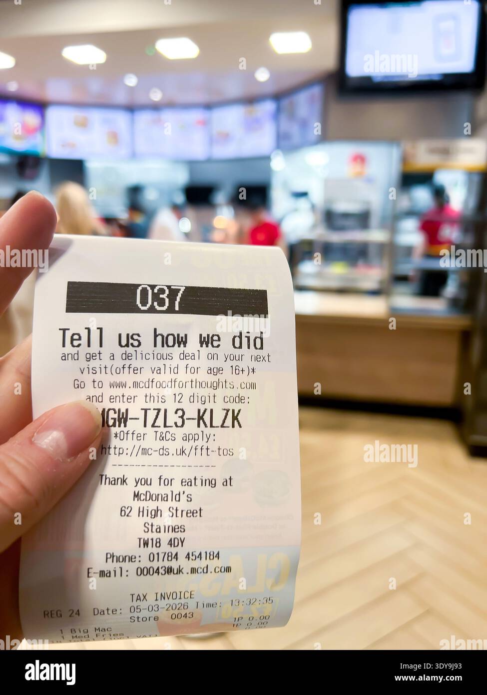Close up of a receipt from a self service ordering machine with an order number at a McDonalds fast food restaurant - Smartphone Captured Stock Image