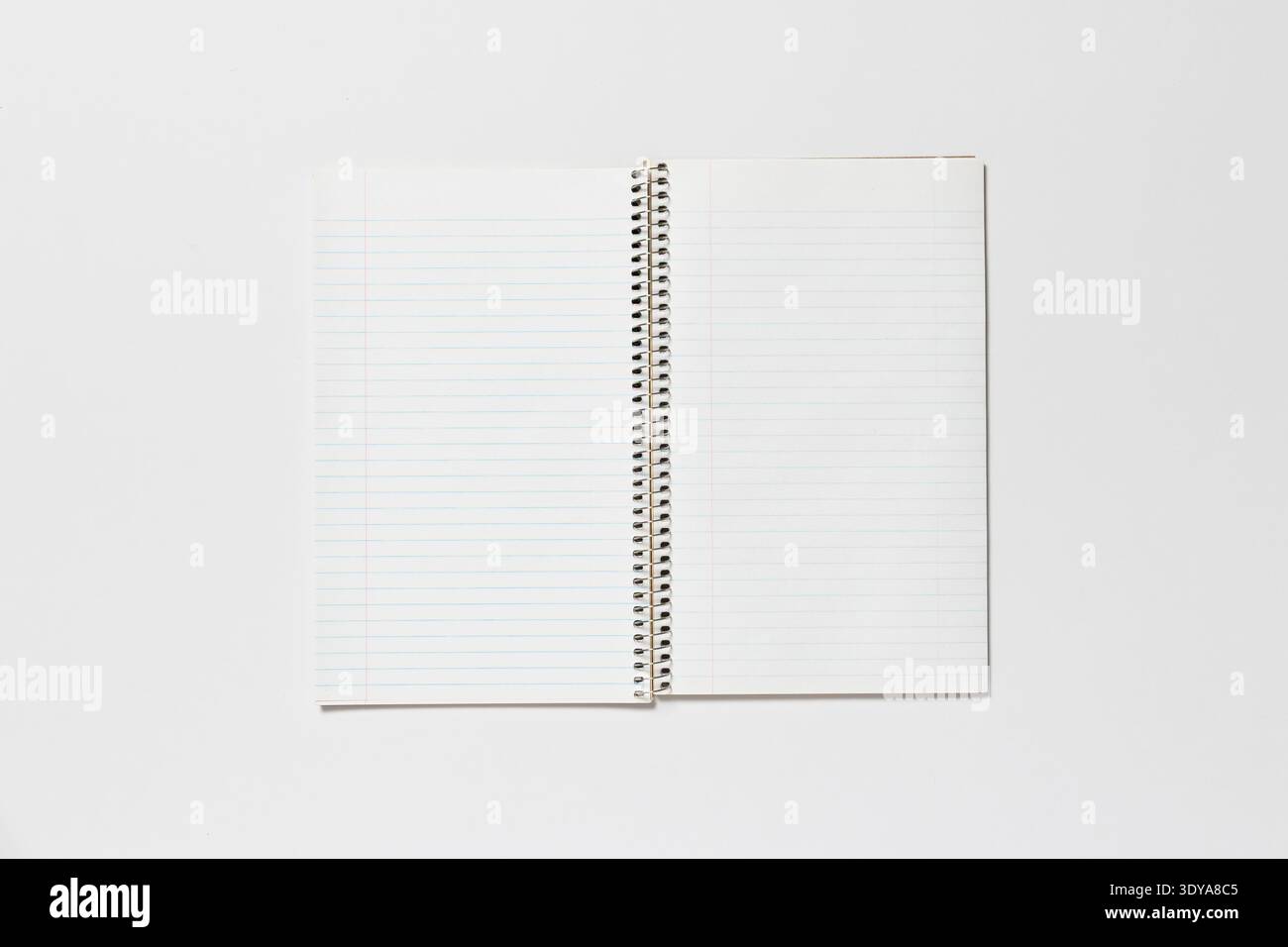 Open spiral notepad on a white background. The page is blank. Stock Photo