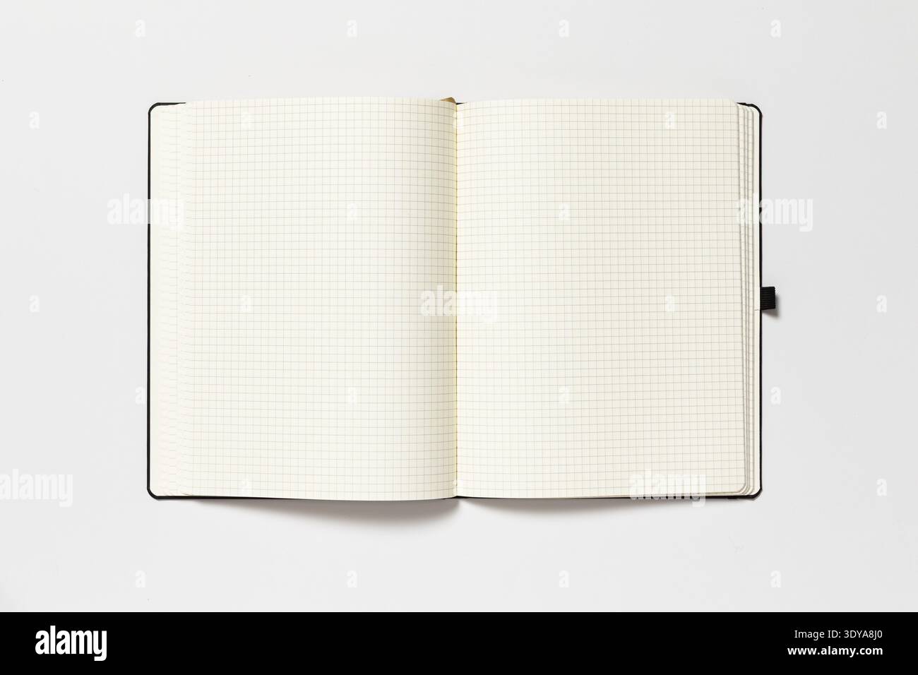 Open notepad on a white background. The page is blank. Stock Photo
