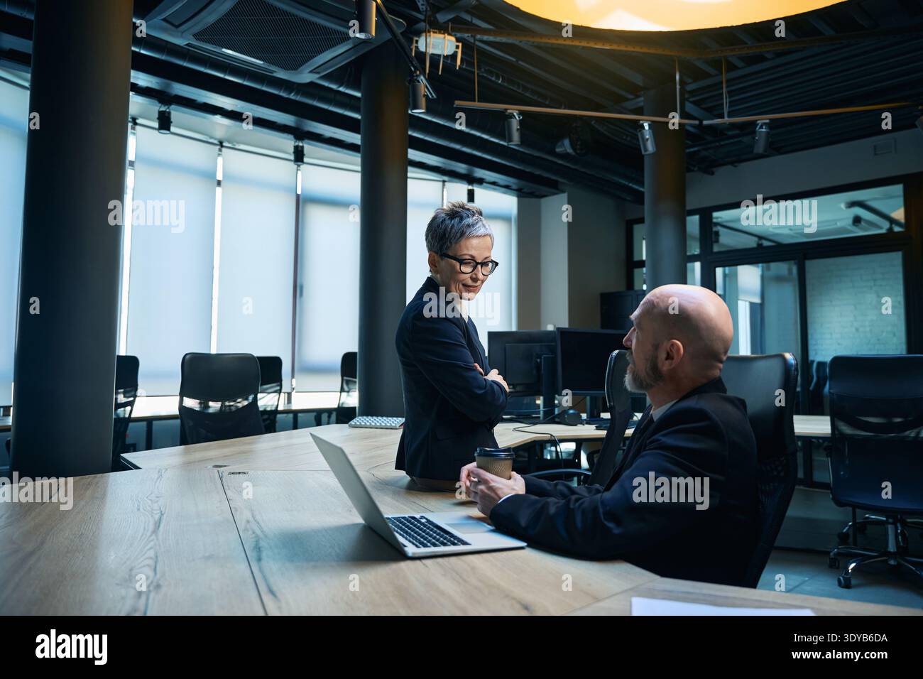 Diverse professionals collaborating in modern office boardroom Stock Photo