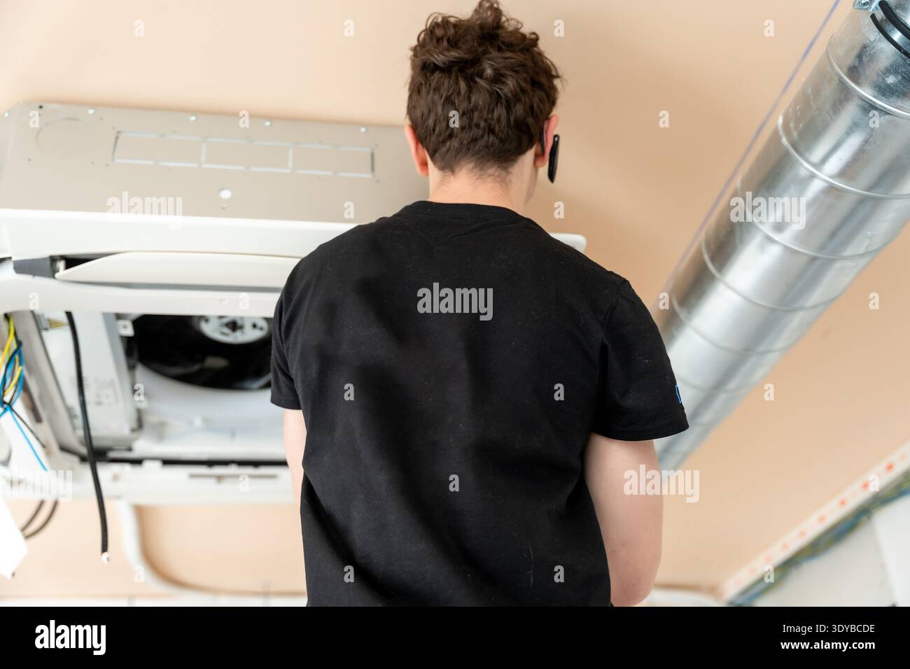 Hvac technician installing air conditioning unit maintenance work Stock Photo