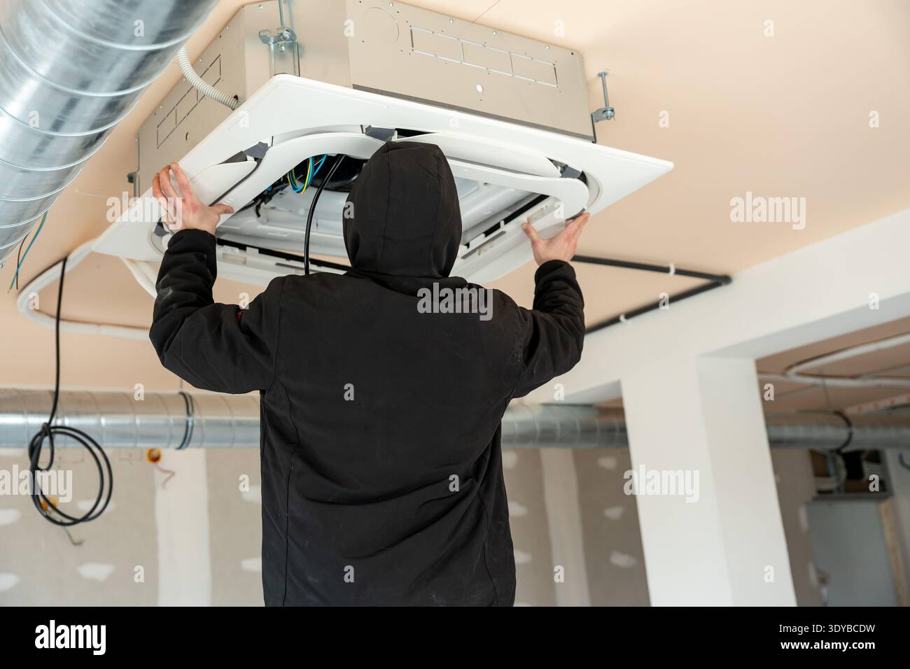 Hvac technician installing air conditioning system Stock Photo