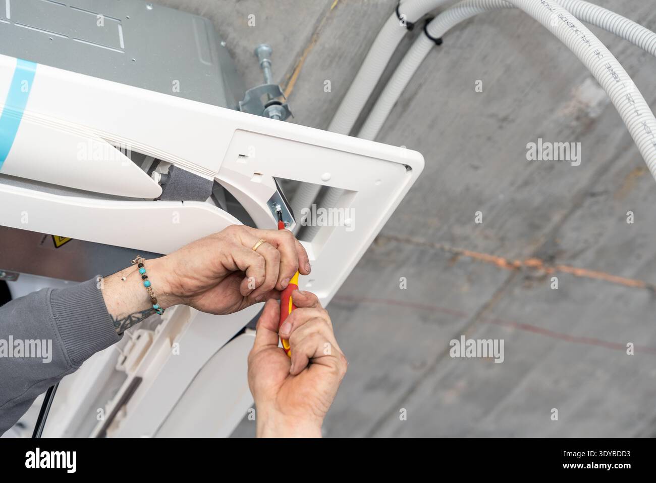 Hvac technician installing air conditioner unit indoors Stock Photo
